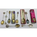 Nine silver souvenir spoons and two mustard spoons,