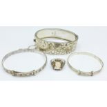 Three silver bangles including one with Victorian hallmark and a ring