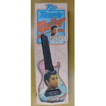 A Grease toy plastic guitar,