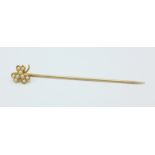 A yellow metal and pearl stick pin,