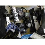 An Olympus IS-1000 video camera, Ricoh KR-10 film camera,