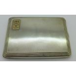 A silver cigarette case,