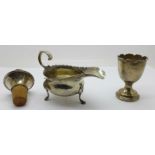 A silver sauce boat, egg cup and bottle stop,