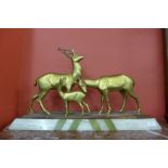 A French Art Deco gilt metal figure of deer, on alabaster plinth, signed R.