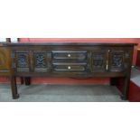 An Elizabeth Revival carved oak dresser