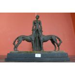 An Art Deco style bronze figure of a lady and two dogs,