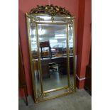 A large French style gilt framed mirror with crest,