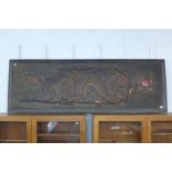 A Chinese embossed dragon wall hanging panel