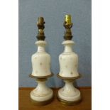 A pair of French style opaline glass and gilt table lamps