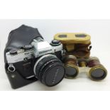 An Olympus OM10 35mm camera and a pair of opera glasses