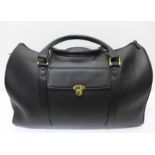 A Montblanc black leather bag with booklet and dust cover,