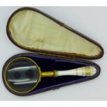 A continental gilt brass and ceramic magnifying glass,