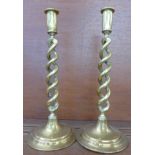 A pair of open twist brass candlesticks,