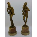 A pair of Art Deco, gilt cast metal figures of musicians on onyx bases,