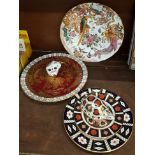 Four Royal Crown Derby plates and two paperweights,