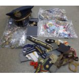 A collection of military buttons, ribbons, cloth badges, a Texas P.D. peaked cap, etc.