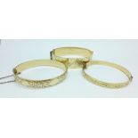 Three rolled gold bangles