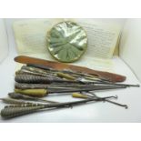 A collection of button hooks, including silver handled, ivory, ebony,