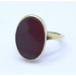 A 9ct gold and onyx ring with unusual off centre setting, 4.