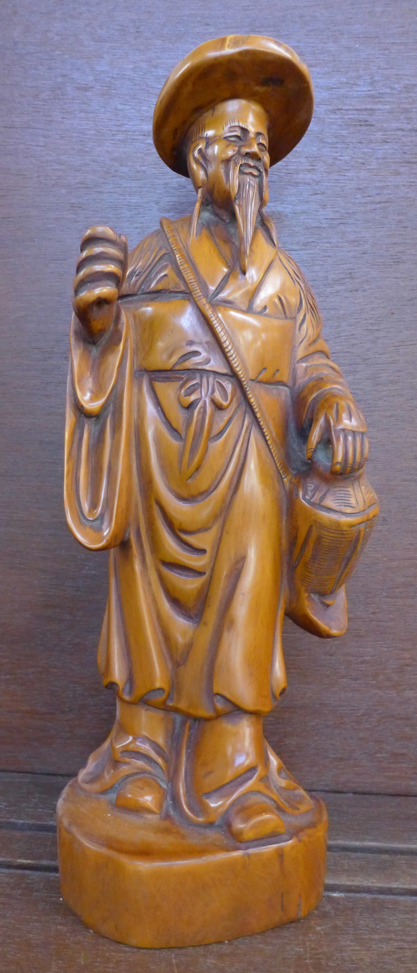 A carved figure of an oriental elder,