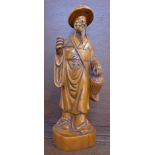 A carved figure of an oriental elder,