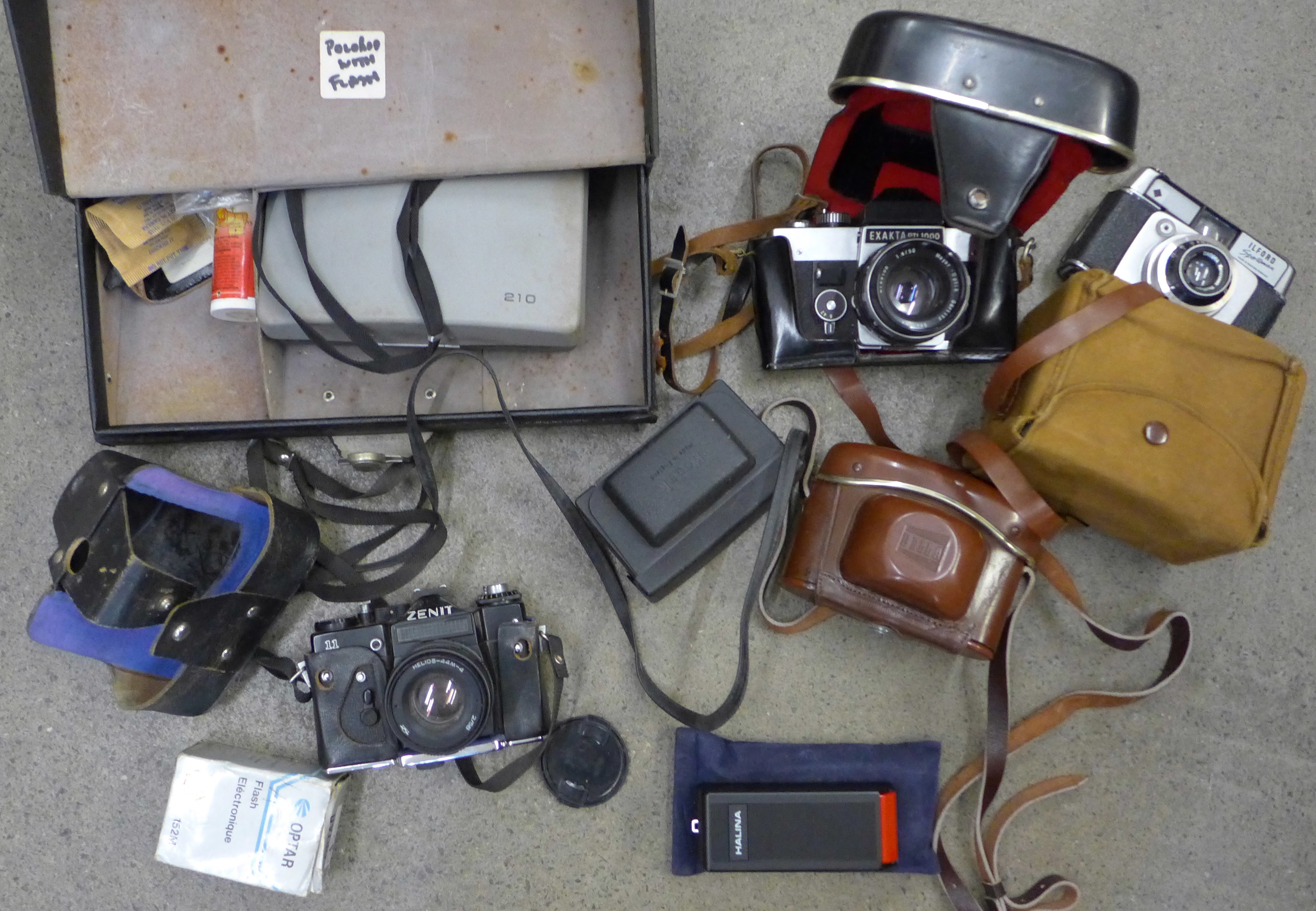A collection of cameras including Exakta, Bella, Polaroid, Zenit, etc.
