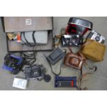 A collection of cameras including Exakta, Bella, Polaroid, Zenit, etc.