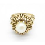 A yellow metal and pearl ring, 6.