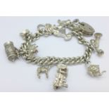 A silver charm bracelet with ten charms,