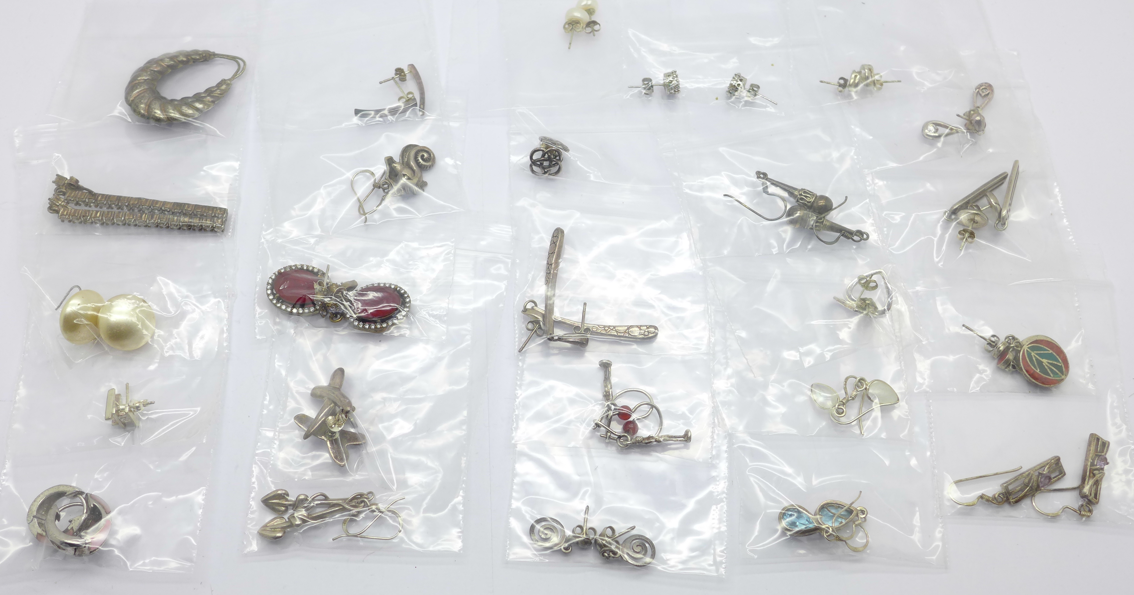 Twenty-five pairs of silver earrings