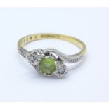 An 18ct gold, platinum set diamond and peridot ring, 2.