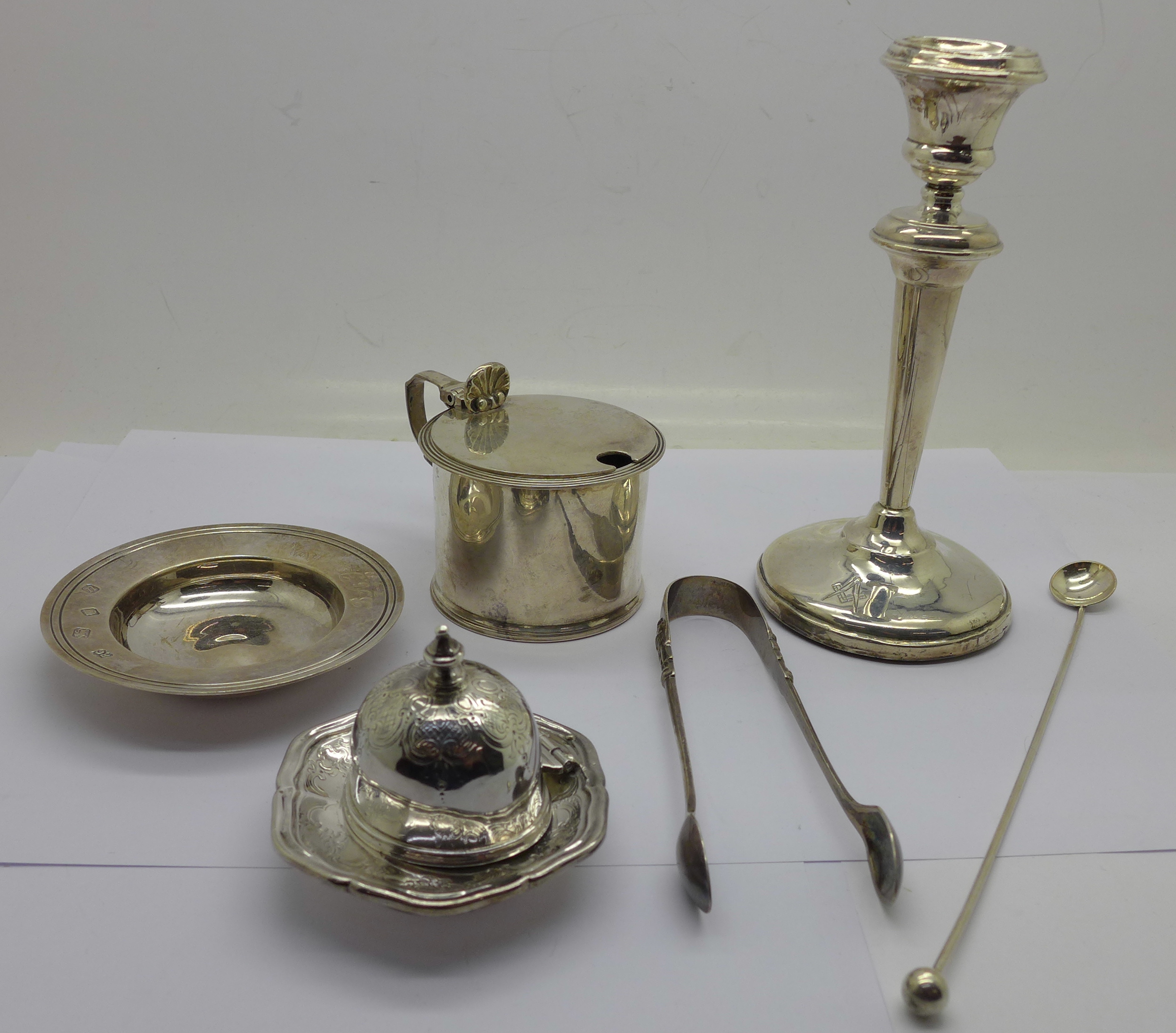 A silver candlestick, silver dish, silver inkwell top, lacking glass,