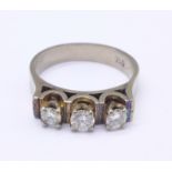 An 18ct gold, three stone diamond ring, 6.