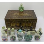 Twelve Chinese snuff boxes within a lacquered box,