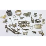 Silver and white jewellery including charm bracelets, brooches,