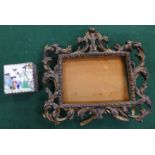 A gilt metal photograph frame and an oriental white metal trinket pot with enamel decorated lid,