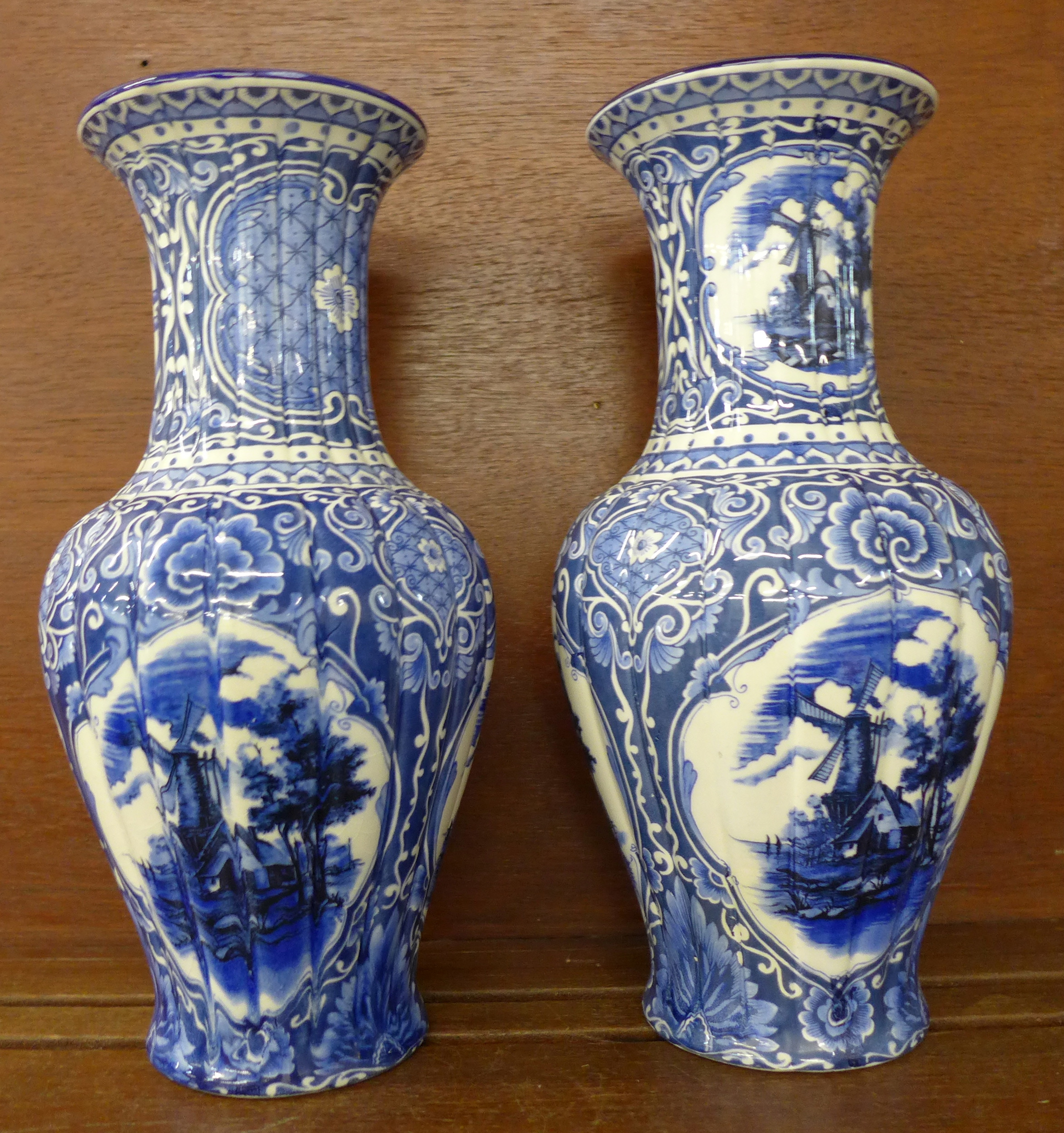 A pair of blue and white vases, one base marked C.