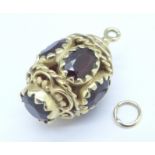 A 9ct gold and garnet charm, 5.