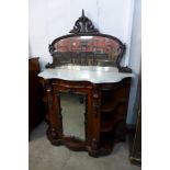 A Victorian carved walnut and marble topped chiffonier
