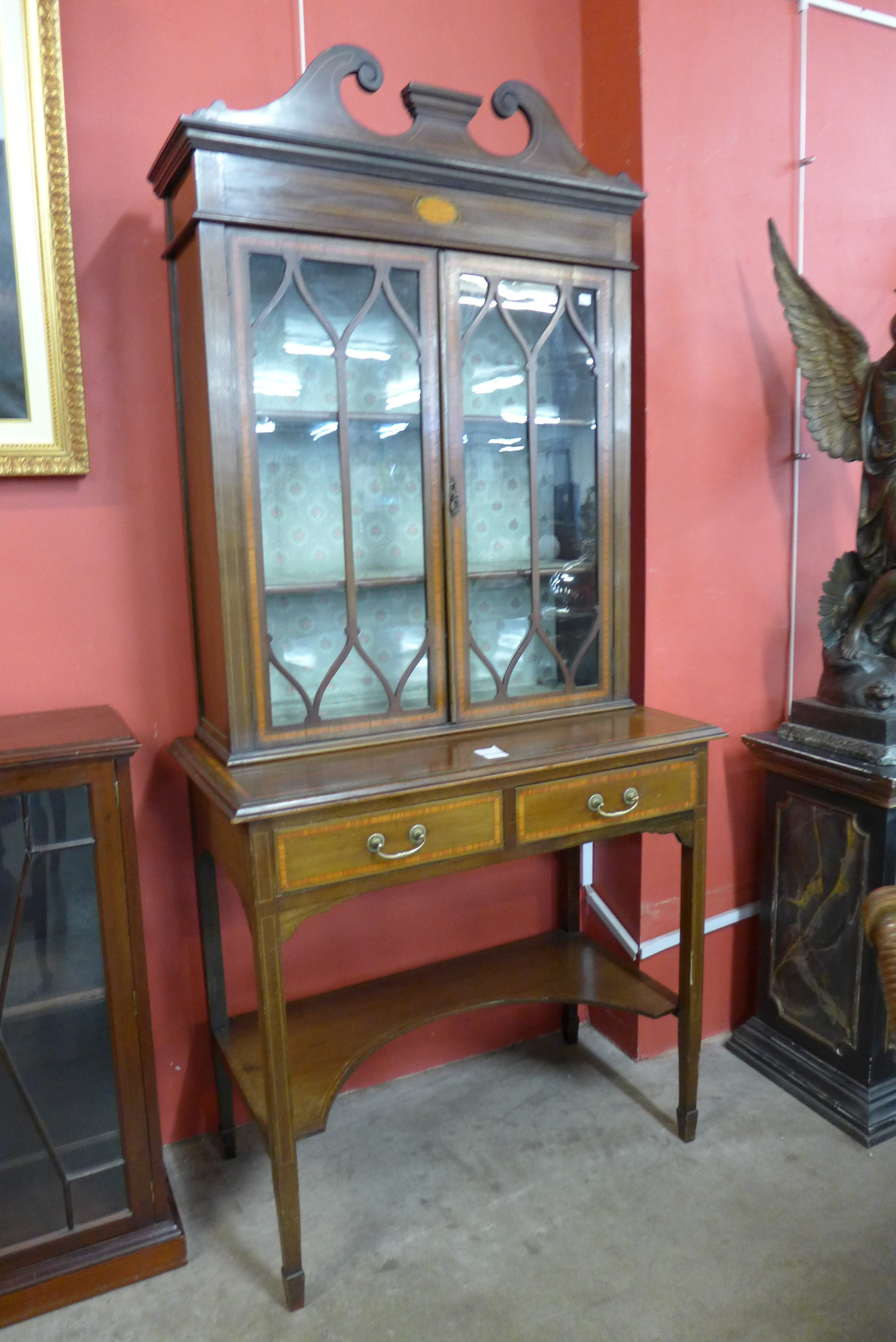 An Edward VII mahogany and satinwood inlaid bookcase on stand