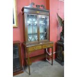 An Edward VII mahogany and satinwood inlaid bookcase on stand