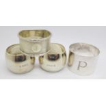 Four silver napkin rings including a pair,