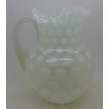 A glass 'coin dot' jug,