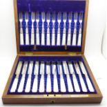 A set of twelve silver and mother of pearl pastry knives and forks,