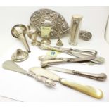 A silver backed hand mirror, silver topped jar, silver handled knives, shoe horns, etc.