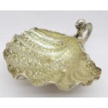 A white metal shell shaped dish with handle, possibly Chinese,