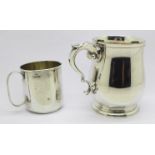 A silver mug and a silver cup,