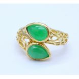 A silver gilt and green stone 'snake' ring,