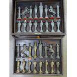 A set of cast metal chess pieces in a wooden case, height of king 14cm,