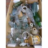 A large collection of glass and stoneware bottles including advertising,